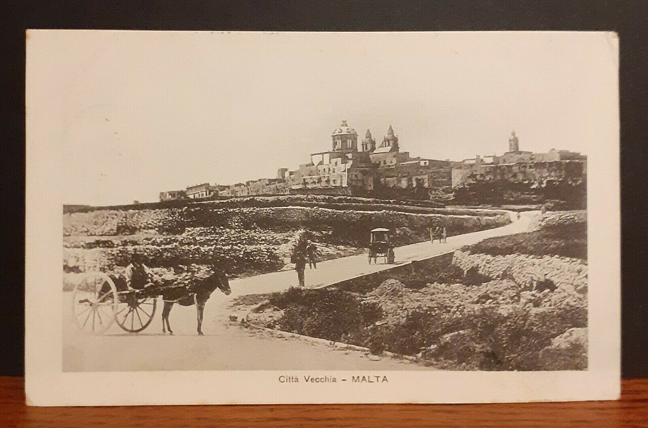 Before and after AI restoration of a 1920s Malta street postcard — Before